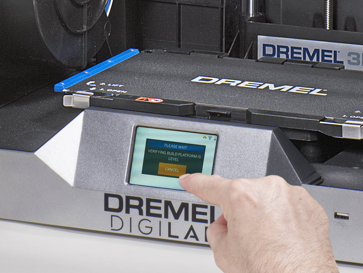 Image of Dremel 3D40-FLX touch screen with a persons finger touching an OK button