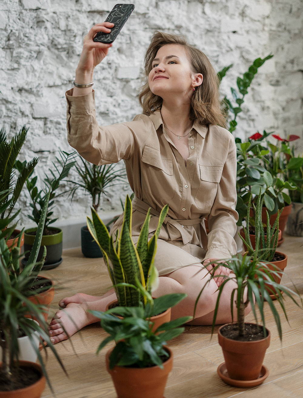 girl taking a selfie with house plants