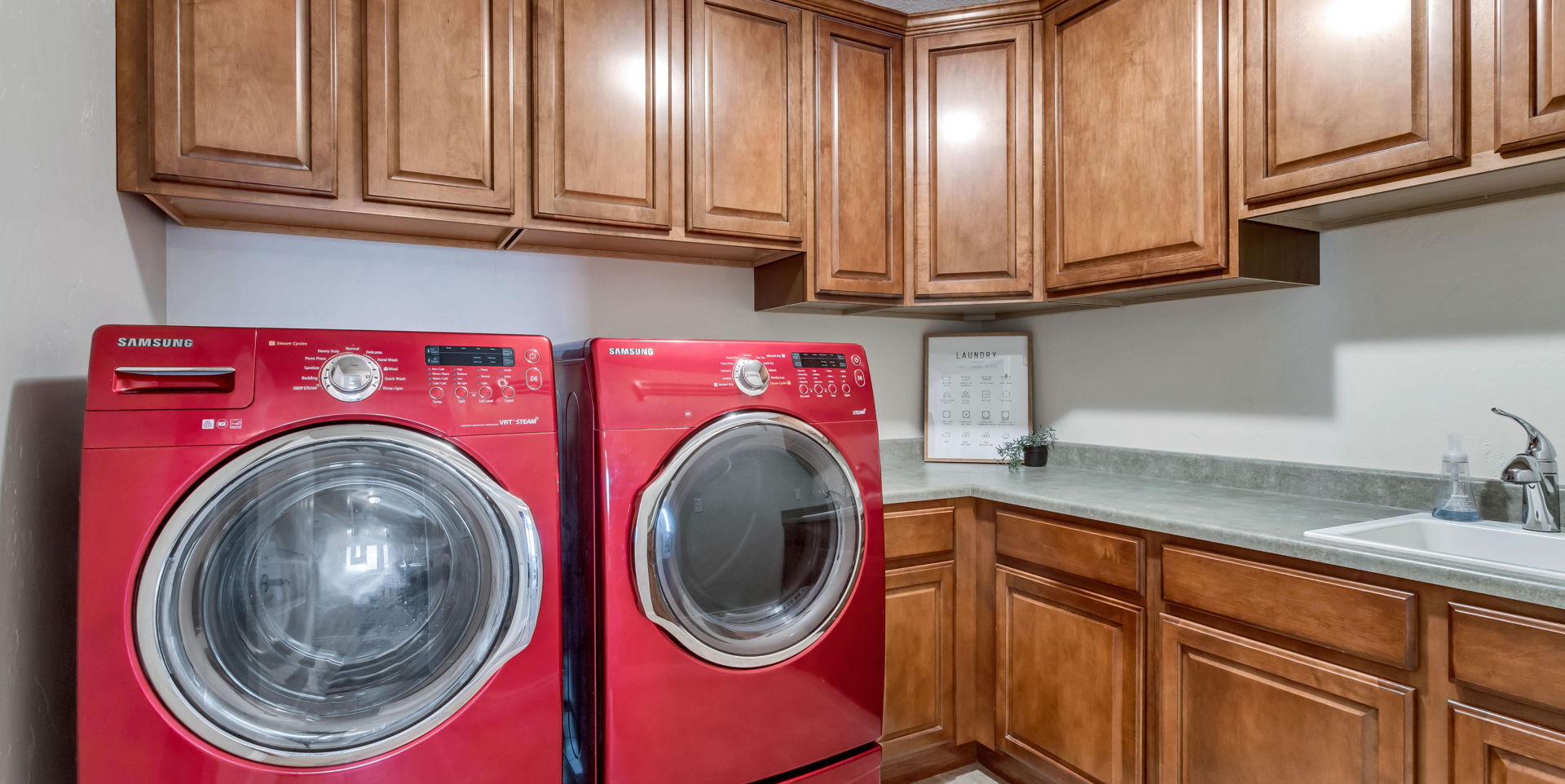 clothes washing area with independent washer and dryer