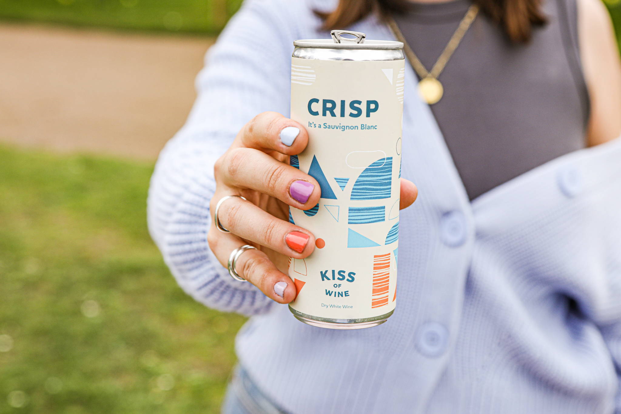 Kiss of Wine Crisp Sauvignon Blanc being enjoyed by a woman.