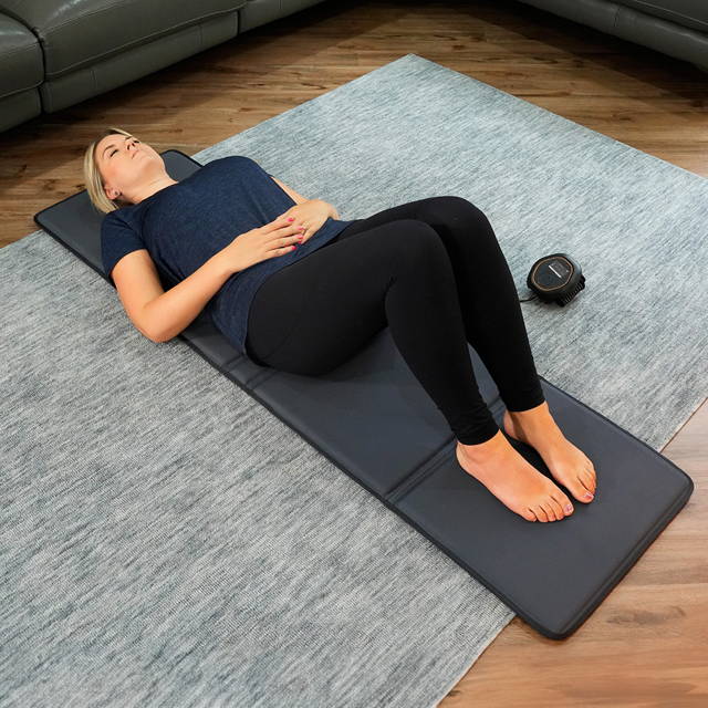 Women laying on CELLER8 full body mat