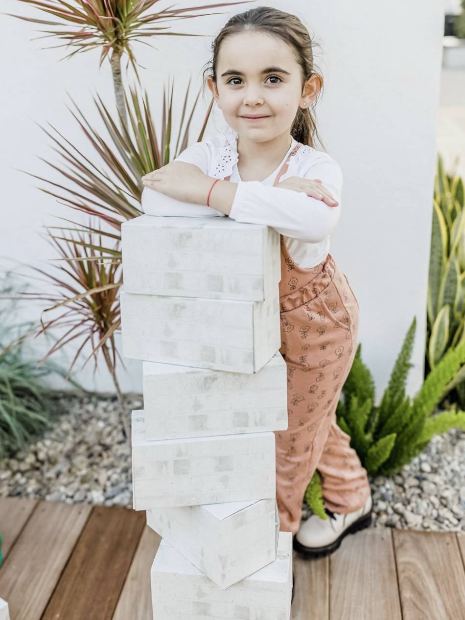 Girl leaning on white building blocks
