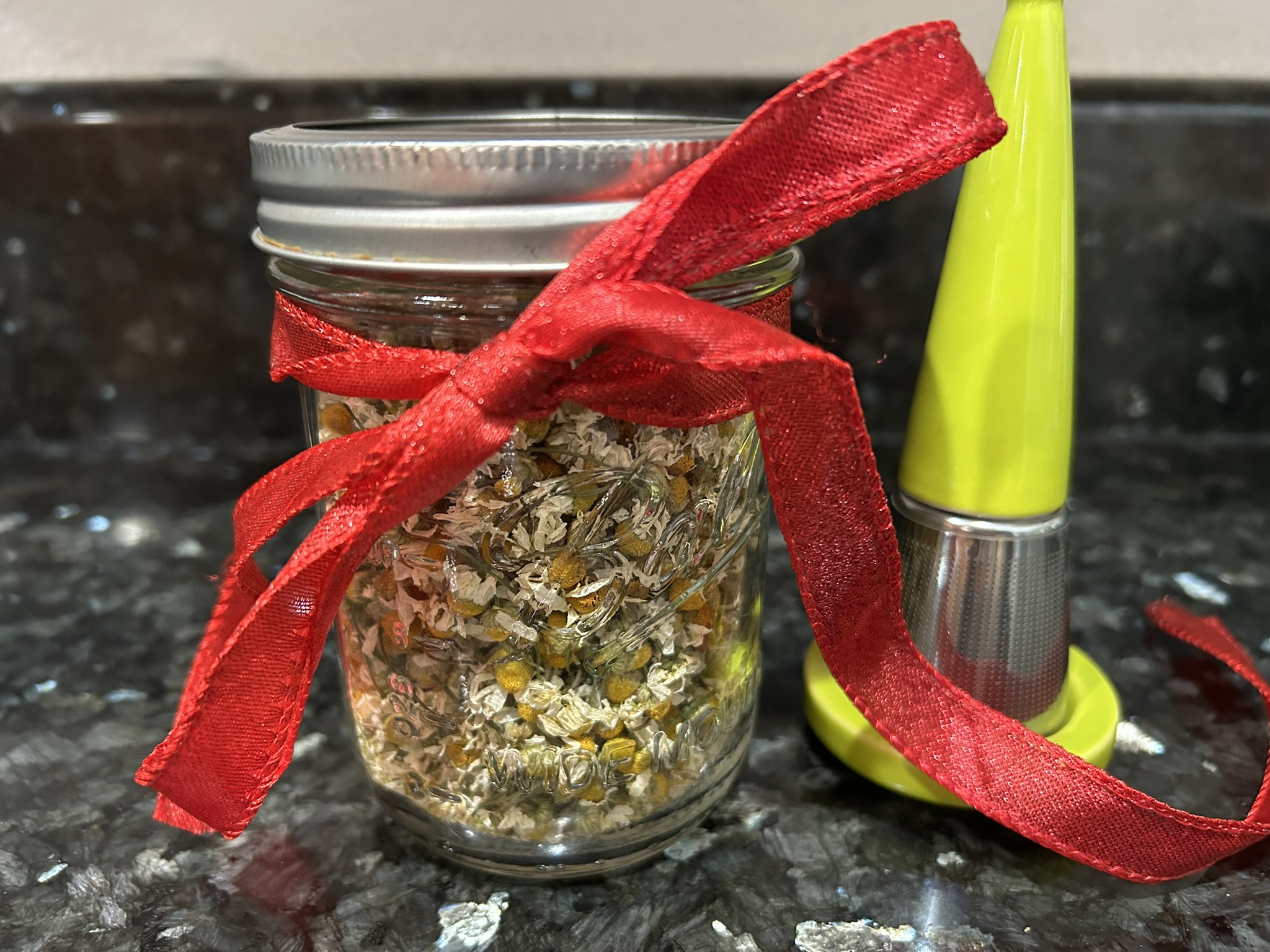 Dried chamomile tea and a green tea infuser