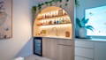 Integrated bar lighting with warm LED strips highlighting shelving and creating a soft ambient glow
