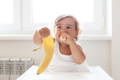 Little girl eating a banana. 