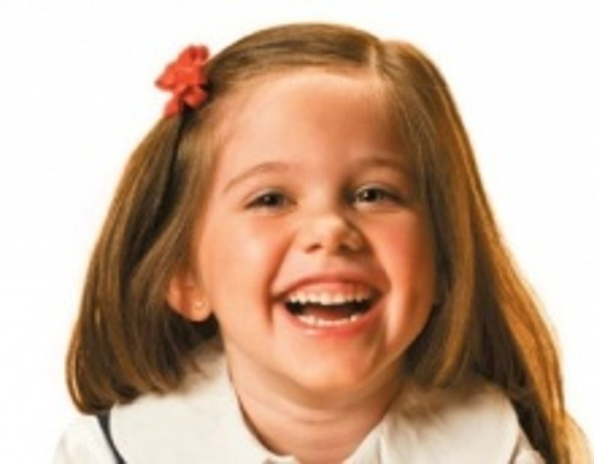 Close up of a young girl laughing heartily