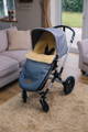 A grey footmuff with honey coloured sheepskin - the kaiser premium for bugaboo - in a bugaboo cameleon