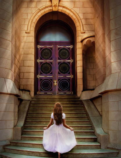 A  young woman in a white dress walking up  the steps to the temple.