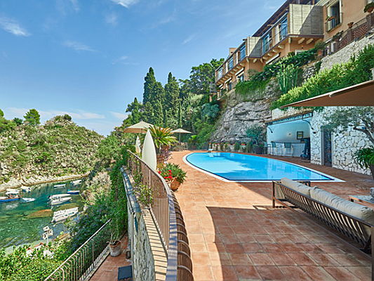  Hamburg
- This exclusive seafront villa with private access to the beach boasts a premium beachfront location in Taormina’s Mermaid Bay, on the east coast of Sicily. The luxurious property, with stunning views of the sea, expands over approximately 690 square meters and offers six bedrooms and eight bathrooms, a large living and dining room, as well as a spacious terrace and swimming pool. (Image source: Engel & Völkers Taormina-Etna)