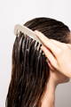 comb brushing through a woman's wet hair