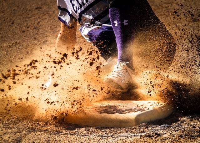 A baseball player slides into a base