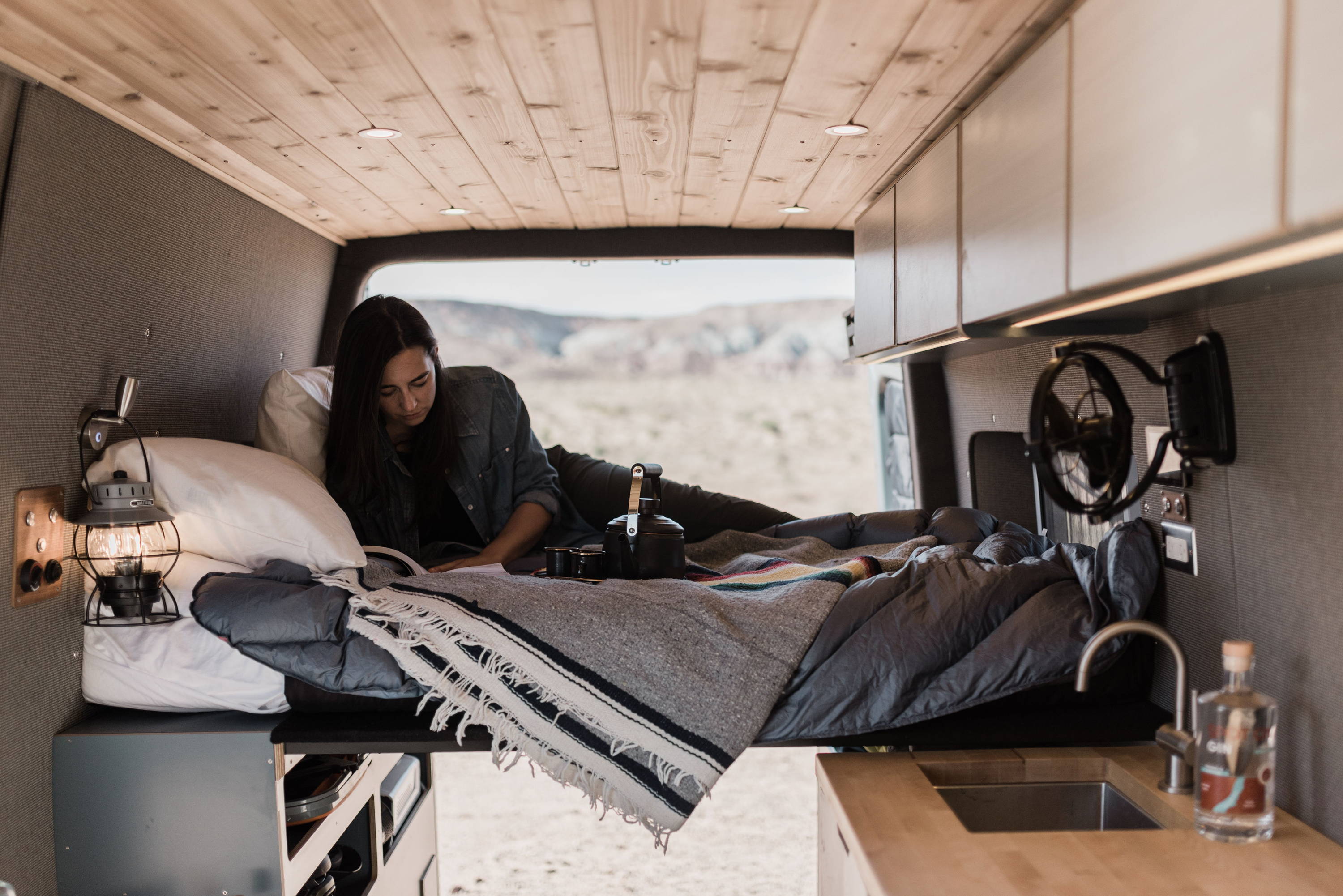 Rack & Roll - Sprinter 144 Conversion Van - Man in Under-Bed Storage Area with Shelves - The Vansmith