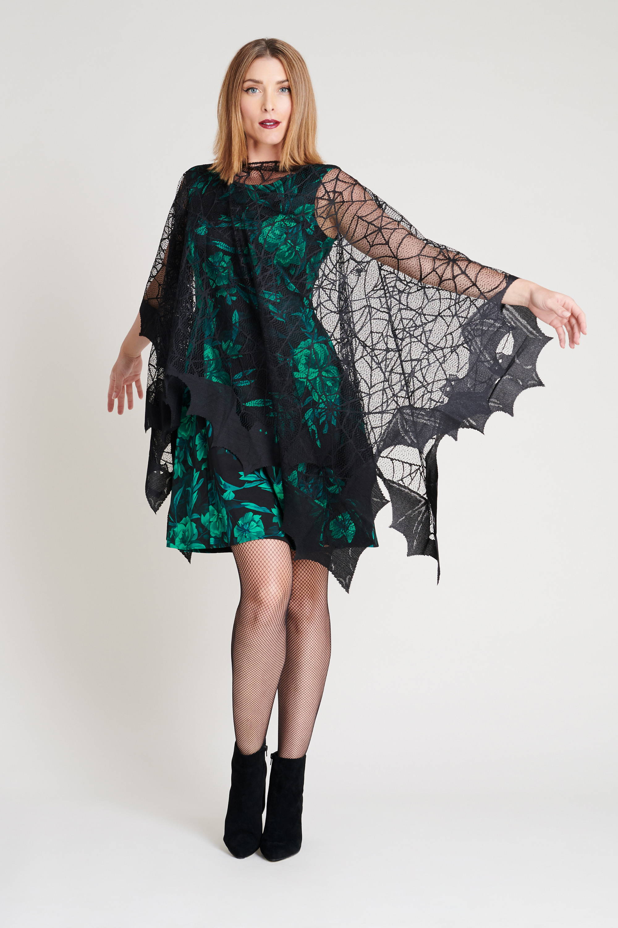 woman in spider web mesh cape and green floral dress on diy halloween costumes connected apparel blog