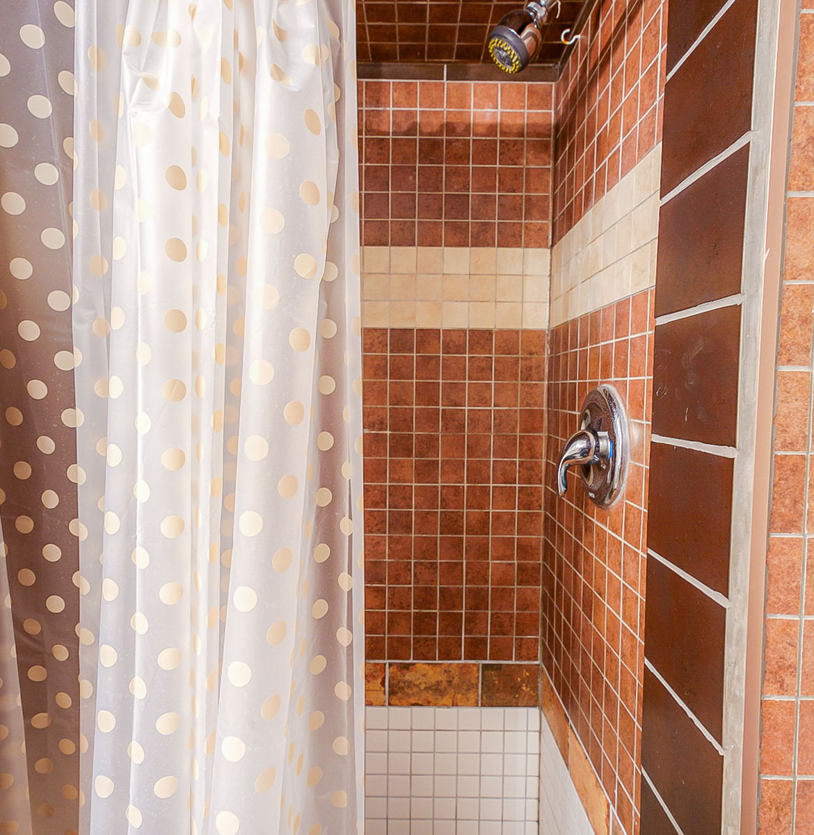 bathroom featuring tile flooring, a shower, and shower curtain