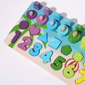 Close up showing the colorful pieces of the Montessori Smart Board such as shapes, numbers, rings, and magnetic fish.