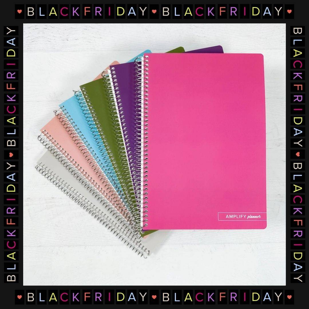 stack of amplify planner spiral notebooks with black friday frame