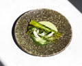 Tofu matcha sauce accompanying spears of asparagus, garnished with sprigs of fennel