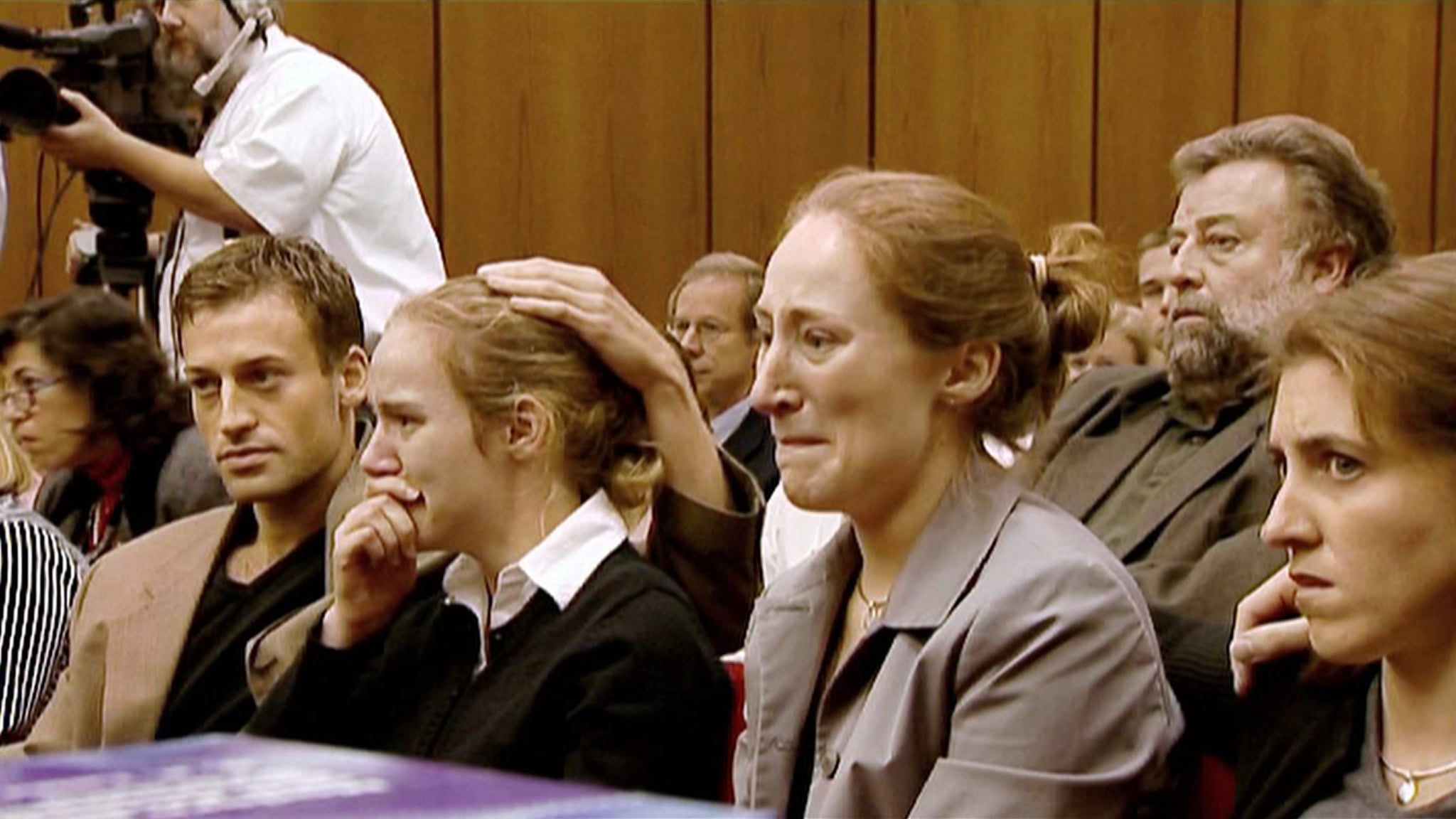 The defendants at the court hearing, crying listening to the case
