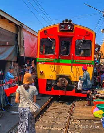 Maeklong Railway Market train passing through the stalls