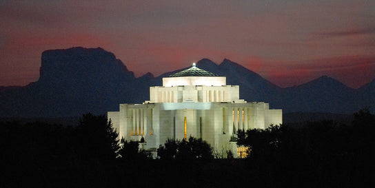 Cardston Temple glowing in the night. 