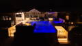 Luxury pool area illuminated with LED strip lighting, step lighting and landscape lighting throughout the outdoor entertaining space.