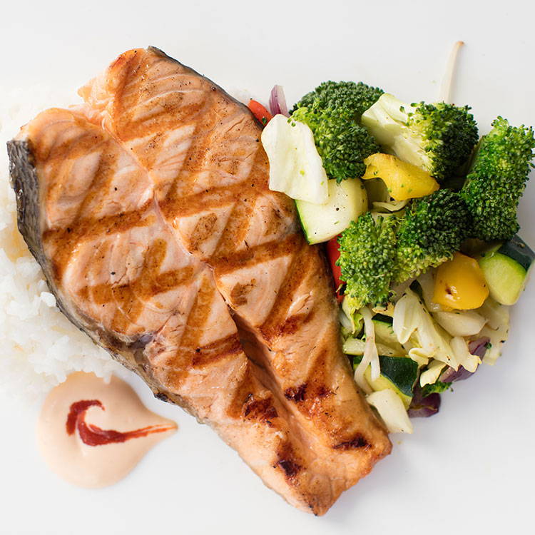 Grilled Fresh Salmon Paired with Grilled Veggies, White Rice, and Tommy Sauce.