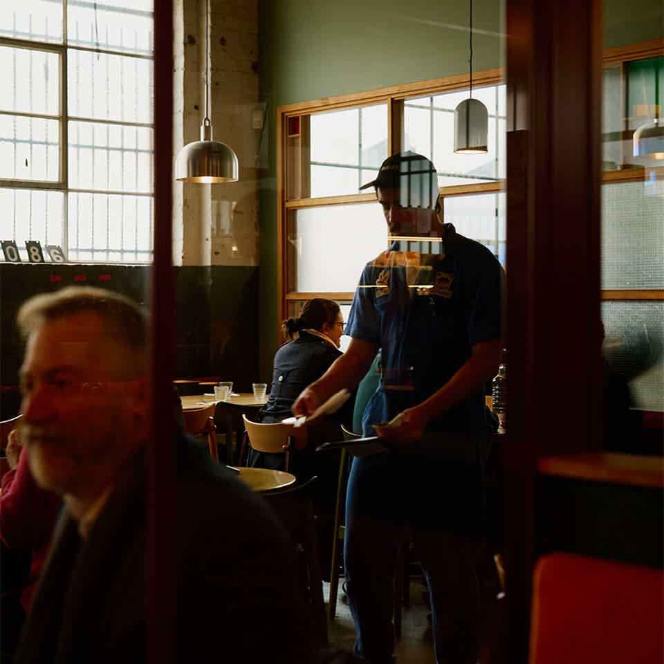 cafe window with people sitting outside