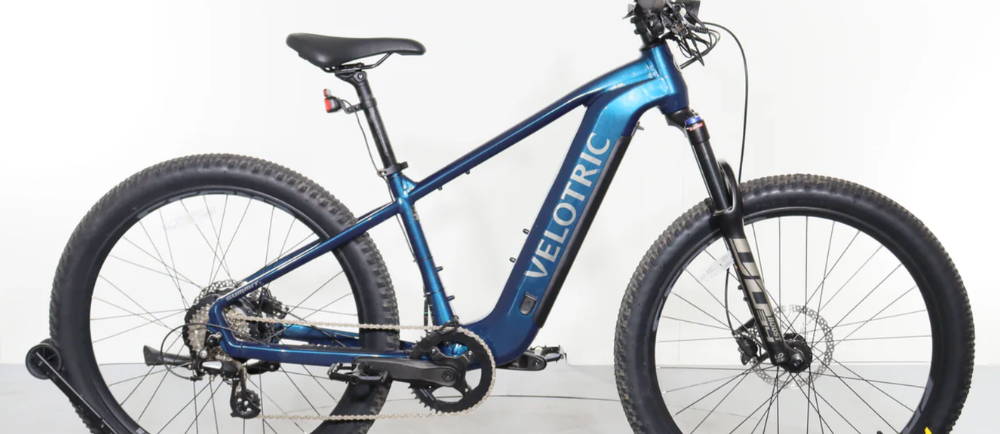a blue Velotric Summit 1 hardtail electric mountain bike