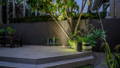 Inground Lighting by Havit uplighting a tree at a backyard deck.