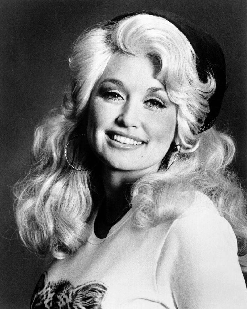 Image may contain: Dolly Parton, Face, Head, Person, Photography, Portrait, Happy, Smile, Blonde, Hair, and Adult