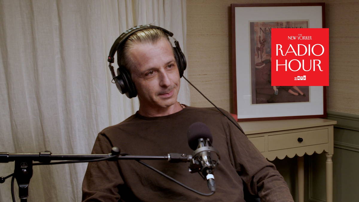 Jeremy Strong sits in a podcast studio.