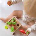 Toddler playing with colorful wooden shapes featured in the Montessori 6-in-1 Sorting Tool toy.