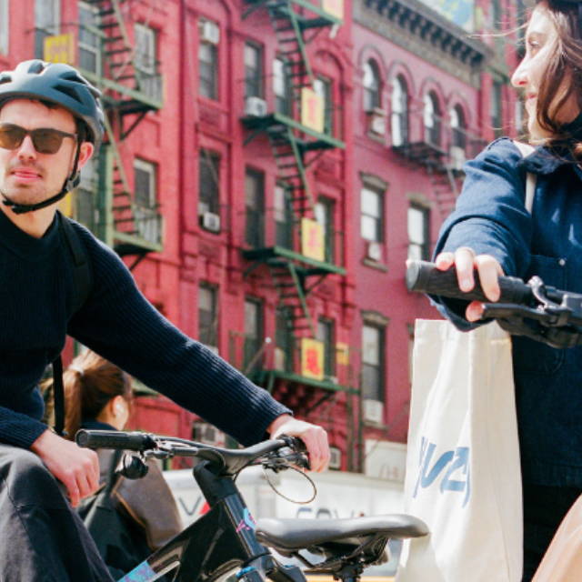 two people e-biking in chinatown