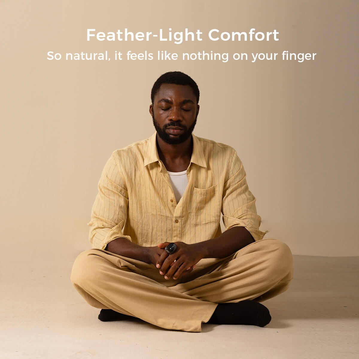 Man meditating while wearing Wellue O2Ring-S smart pulse oximeter, product box visible