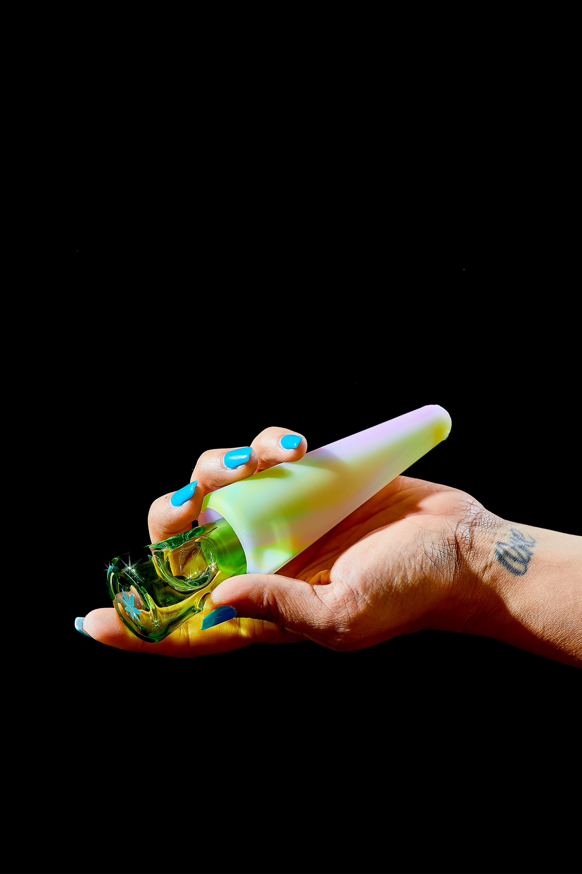 a green glass, glow-in-the-dark glass bong by session goods on a black background