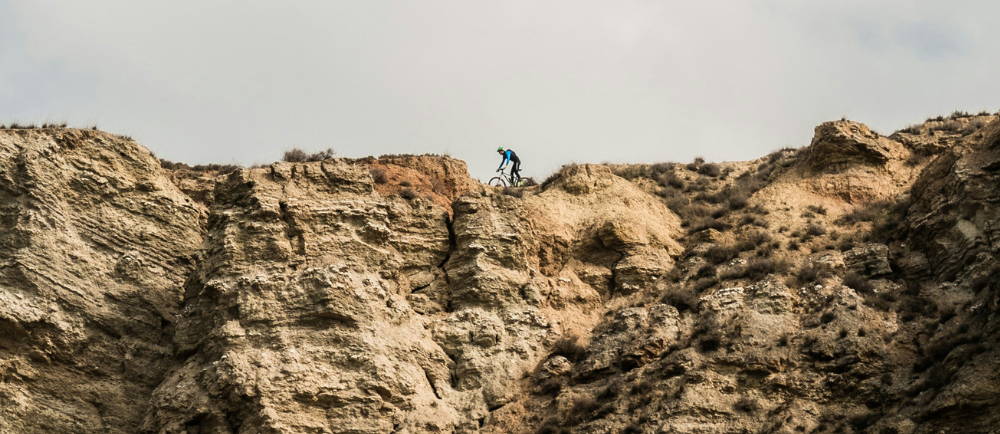 An electric mountain biker riding along a ridgeline