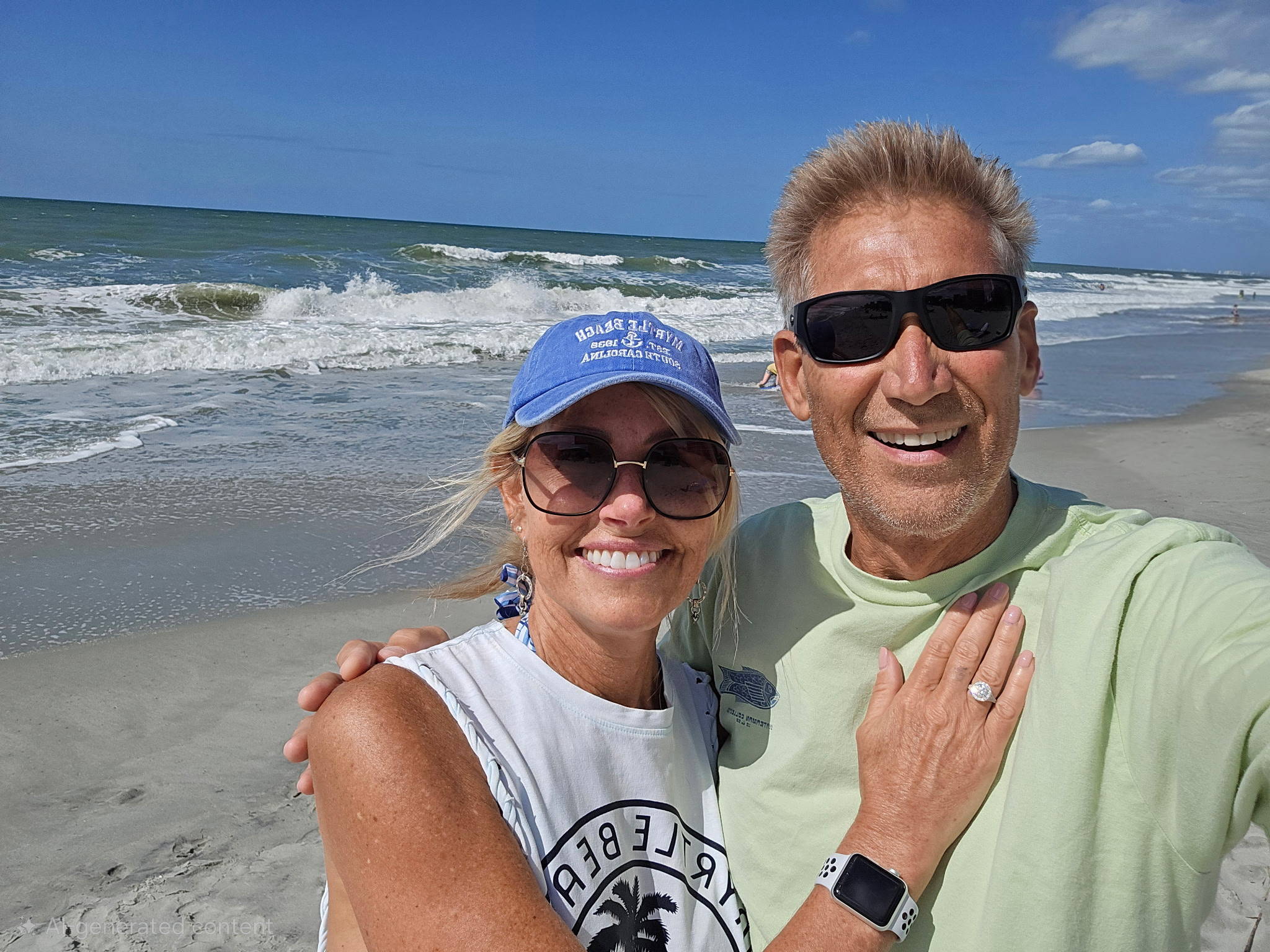 Gerry Turner and Lana Sutton wearing shades and taking a selfie at the beach.