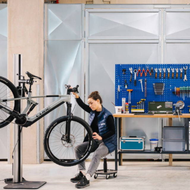 A mechanic working on an electric mountain bike