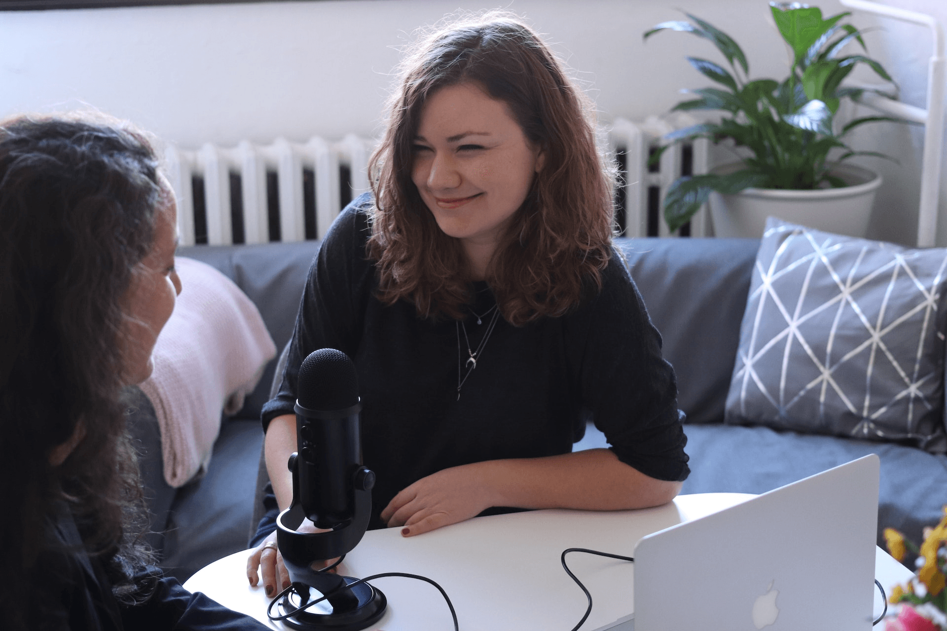 A person holding a microphone and recording equipment, representing how to start a podcast with no audience