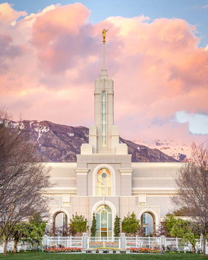 LDS art photo of the Mount Timpanogos Temple in front of mountains and pink clouds. 