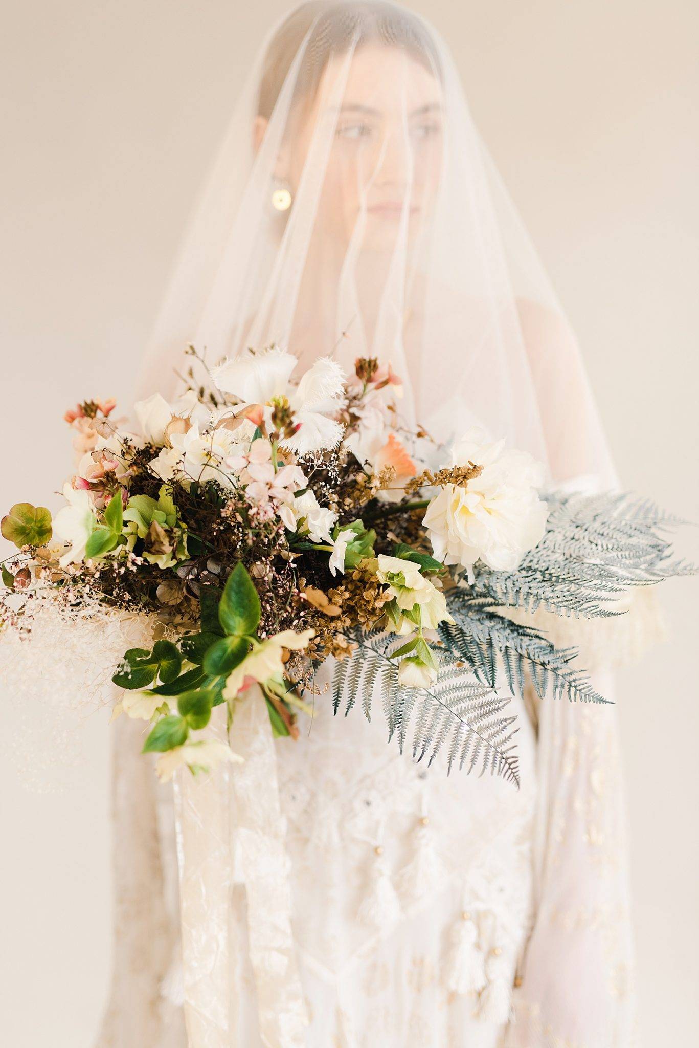 Luxury Wedding Editorial: Bride with Veil Down Holding a Bouquet