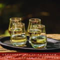 Quatre verres de dégustation Glencairn de Single Malt Scotch Whisky posés sur un plateau noir