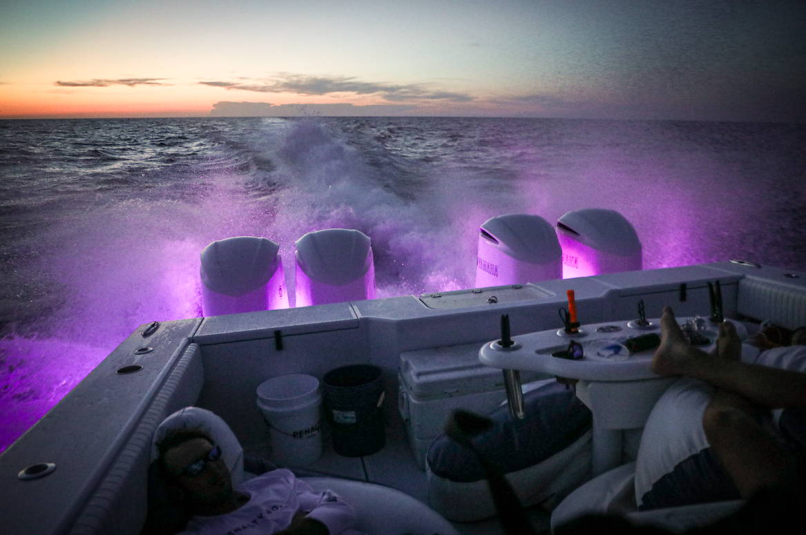 4-engine offshore boat night boating at dusk.