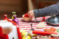 Child playing with pretend play wooden kitchen toys.