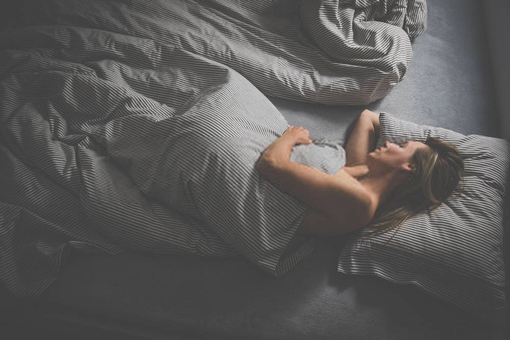 Young woman sleeping in bed