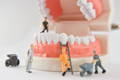 miniature people to repair and clean a tooth