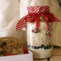 A large glass jar filled with oats covered with a red and white napkin tied with a bow