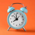 turquoise-vintage-alarm-clock-on-orange-background