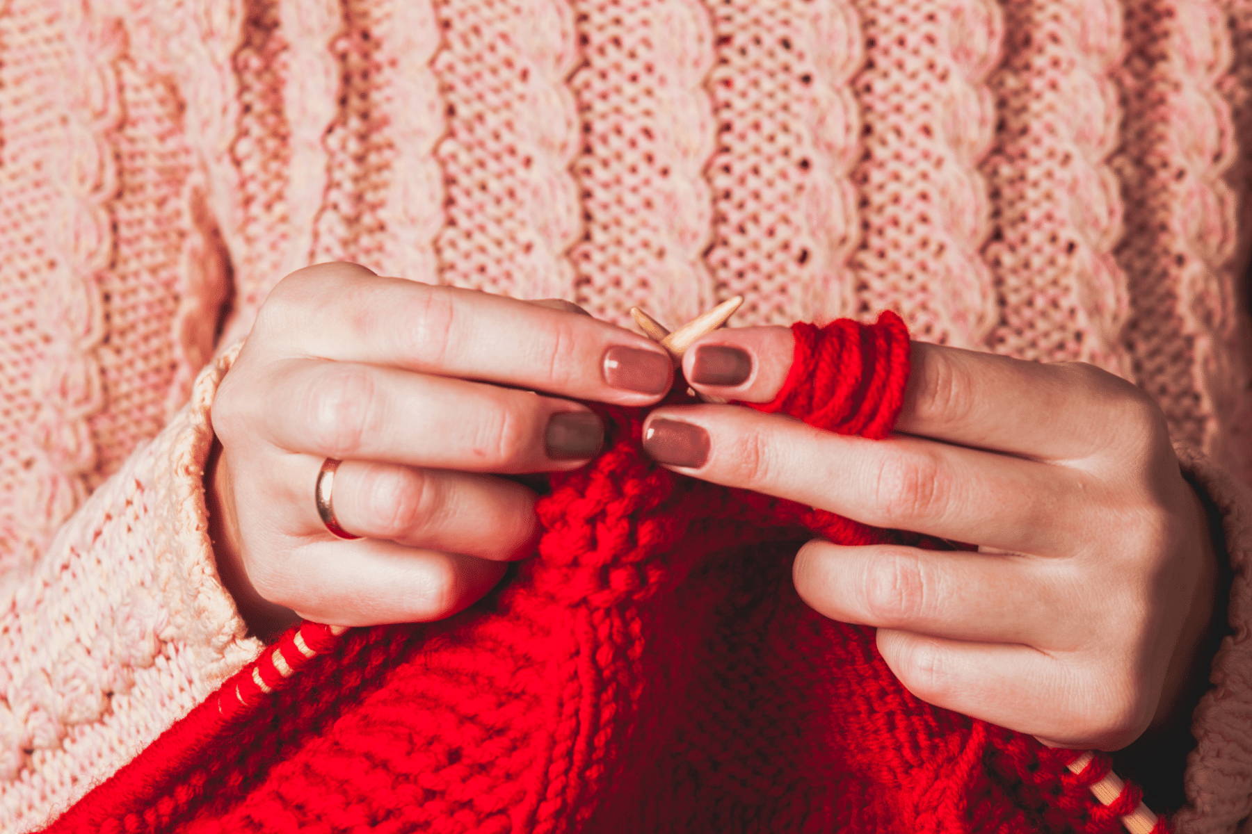 woman knitting a red sweter