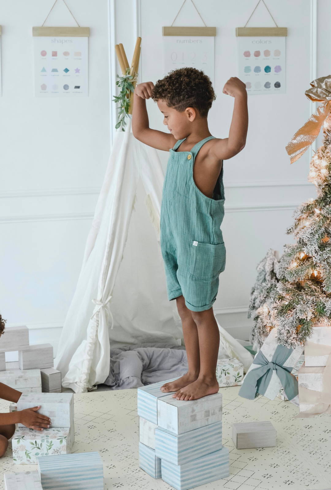 toddler sitting on white building blocks